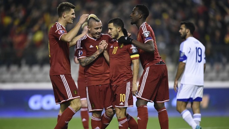 Belgium's midfielder Eden Hazard is congratulated by teammates after scoring a goal during the Euro 2016 qualifying football match between Belgium and Israel at the King Baudouin Stadium