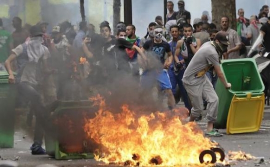 Pro-Palestinian protesters face police during a demonstration against violence in the Gaza strip which had been banned by police in Paris