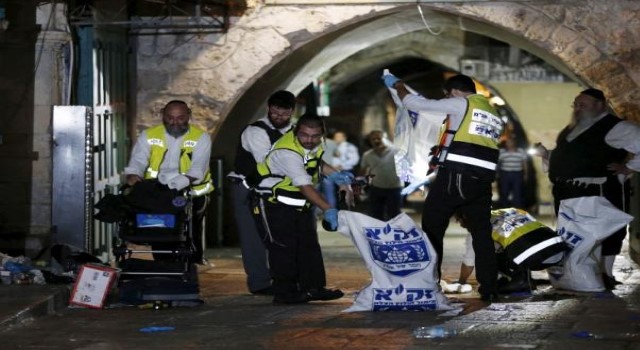 Members of the Zaka Rescue and Recovery team clean the scene where a Palestinian was shot dead after he stabbed and killed two people in Jerusalem's Old City