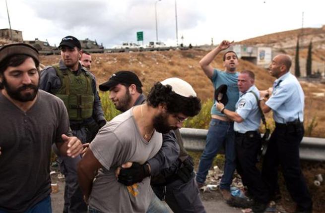 Israeli forces and settlers are seen near the Palestinian town of Beit Sahour in the West Bank