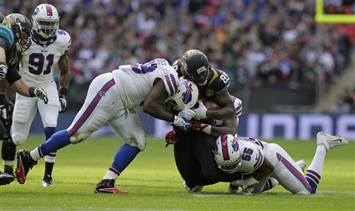 Jacksonville Jaguars tight end Marcedes Lewis, centre is tackled during the NFL game between Buffalo Bills and Jacksonville Jaguars at Wembley Stadium in London Sunday Oct. 25 2015