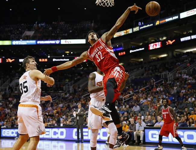 Houston Rockets K.J. Mc Daniels is fouled by Phoenix Suns Mirza Teletovic, of Bosnia & Herzegovina during the first half of an NBA preseason basketball game Tuesday Oct. 13 2015 in Phoenix