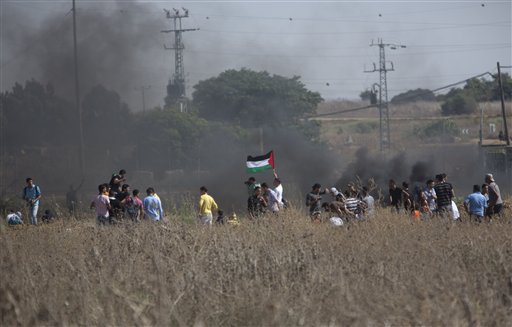 Palestinian protesters gather during clashes with Israeli soldiers on the Israeli border Eastern Gaza City