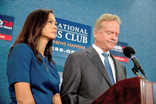 Former Virginia Sen. Jim Webb accompanied by his wife Hong Le Webb pauses as he announces he will drop out of the Democratic race for president Tuesday during a news conference at the National Press Club in Washington