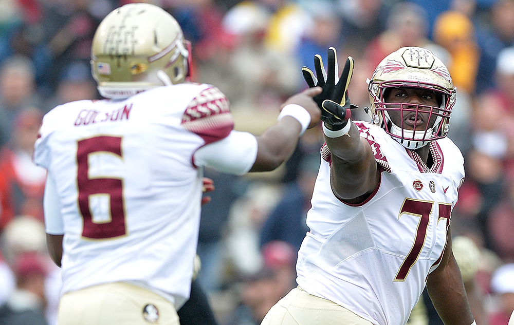 Roderick Johnson #77 confirms the play call with Everett Golson #6 of the Florida State Seminoles during their game against the Wake Forest Demon Deacons at BB&T Field