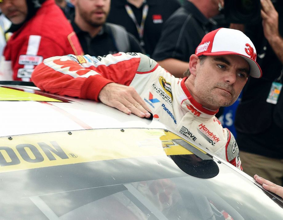 Jeff Gordon climbs out of his car after winning the pole during qualifying for the NASCAR Sprint Cup Series auto race at Talladega Superspeedway Saturday Oct. 24 2015 in Talladega Ala