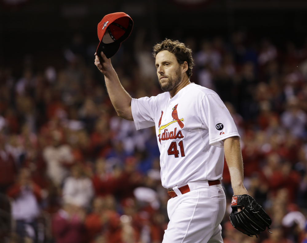 John Lackey tips his cap to the crowd after being taken out during the eighth inning of Friday night’s National League Division Series opener against the Chicago Cubs. Lackey didn’t give up a hit until the sixth inning