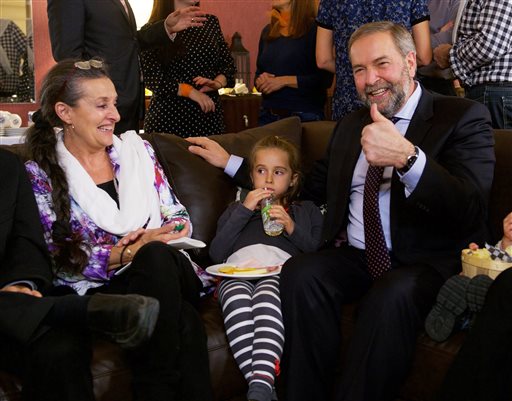 New Democratic Party Leader Tom Mulcair gestures as he watches the election results come in with his wife Catherine and granddaughter Juliette Monday Oct. 19 2015 in Montreal. MANDATORY CREDIT