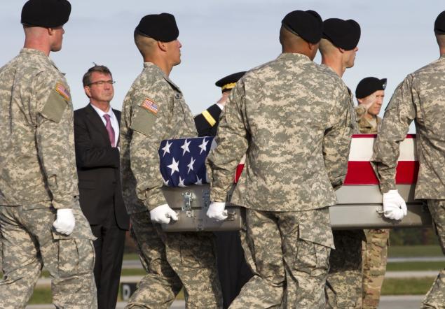 Defense Secretary Ash Carter salutes the remains of Army Master Sgt. Joshua L. Wheeler upon arrival at Dover Air Force Base Del