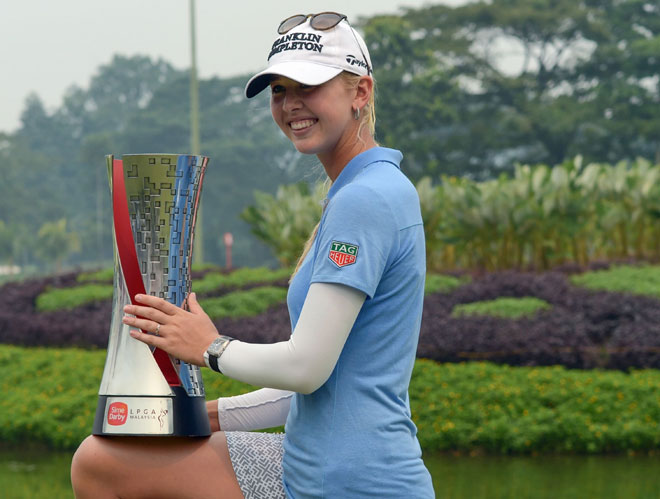 Jessica Korda of the US poses with the winner’s trophy after her victory in the final round of the Sime Darby LPGA Malaysia 2015 golf tournament at the Kuala Lumpur Golf and Country Club. — AFP