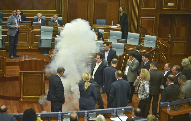 Opposition members of the Kosovo parliament released smoke bombs and blew on whistles to disrupt a parliamentary session Thursday