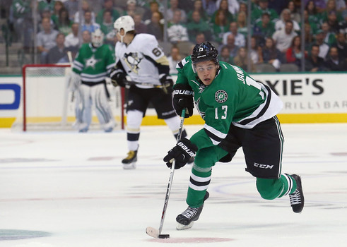 Mattias Janmark #13 of the Dallas Stars controls the puck against the Pittsburgh Penguins in the first period at American Airlines Center