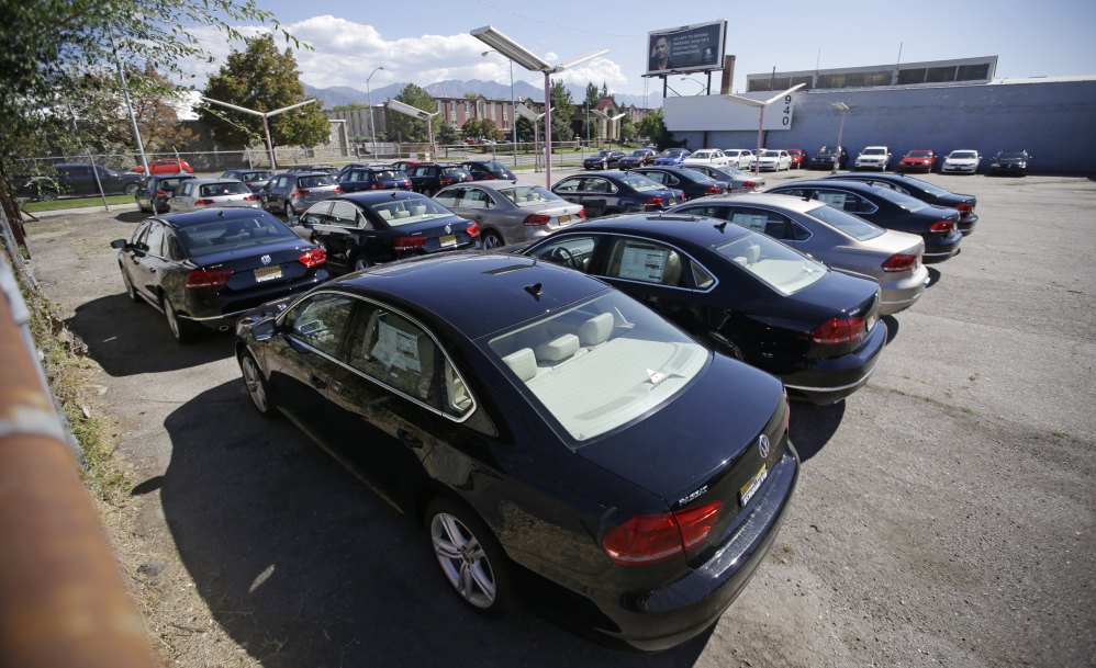 Volkswagen diesel cars are shown are parked in a storage lot near a VW dealership in Salt Lake City. Some legal experts say the automaker could be forced to buy back the cars altogether