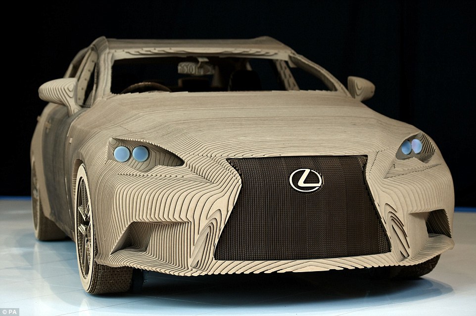 The full scale cardboard replica of the Lexus IS has fully fitted interior functioning doors headlights and wheels with an electric motor mounted on its steel and aluminium frame