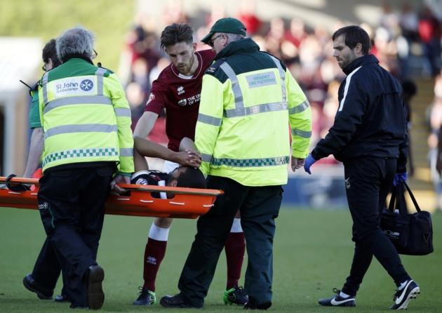 Leyton Orient forward Paul Mc Callum is taken off on a stretcher with his Northampton Town rival Shaun Brisley checking he is okay (pic Simon O