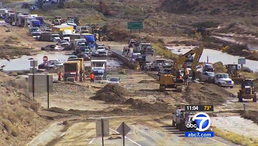 This image made from video provided by KABC-TV shows some of hundreds of big rigs and cars stranded on State Highway 58 near Mojave Calif. Friday Oct. 16 2015 after torrential rains Thursday caused mudslides that carried away vehicles and closed road