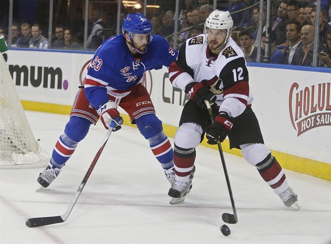 New York Rangers Keith Yandle defends Arizona Coyotes Brad Richardson during the first period of an NHL hockey game Thursday Oct. 22 2015 in New York