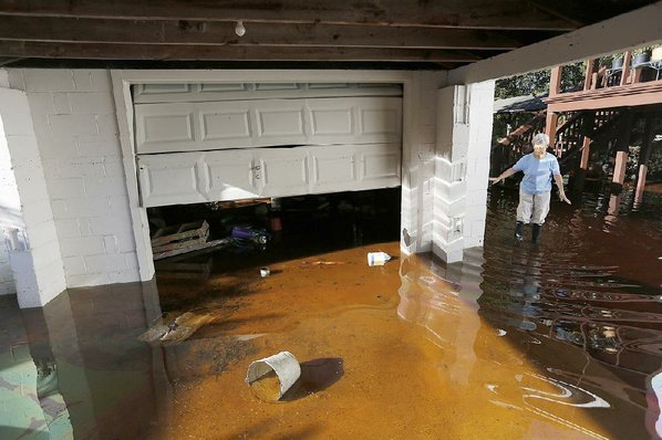 MIC SMITH							Credit AP				Roberta Albers checks on her home Wednesday after floodwaters started to recede at French Quarter Creek in Huger S.C