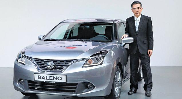 T Suzuki President and COO Suzuki with premium hatchback Baleno at the Frankfurt Motor Show. Baleno to be manufactured exclusively in India for global markets will be launched by Maruti in India in the next few weeks PTI