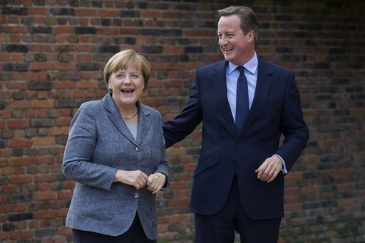 British Prime Minister David Cameron smiles as he talks with German Chancellor Angela Merkel during their meeting at Chequers the prime minister's official country residence near Ellesborough northwest of London Friday Oct. 9 2015. (Justin Talli