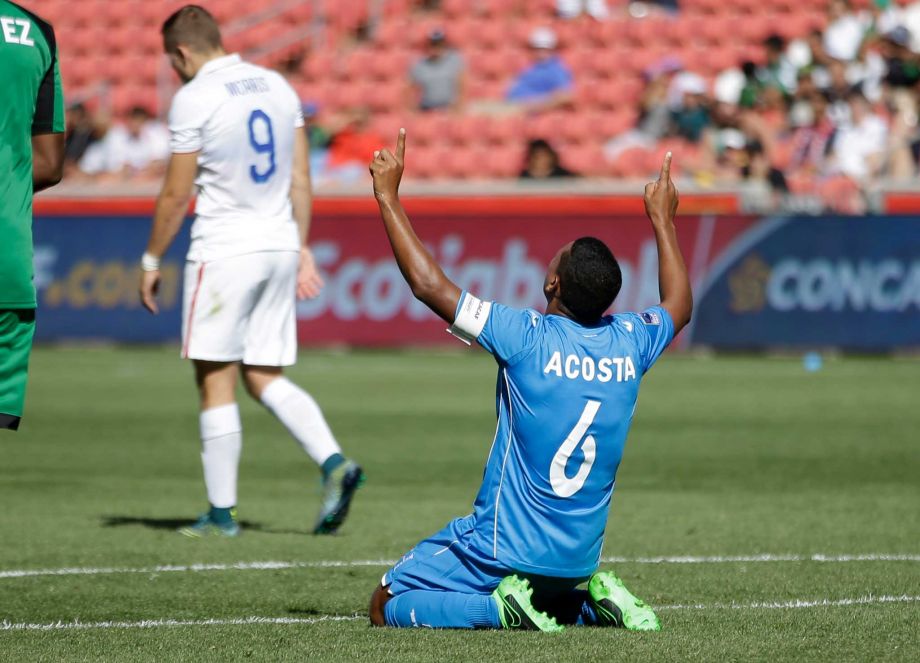 Honduras midfielder Bryan Acosta celebrates as United States forward Jordan Morris walks off following a CONCACAF men's Olympics semifinal qualifying soccer match Saturday Oct. 10 2015 in Sandy Utah. Honduras won 2-0