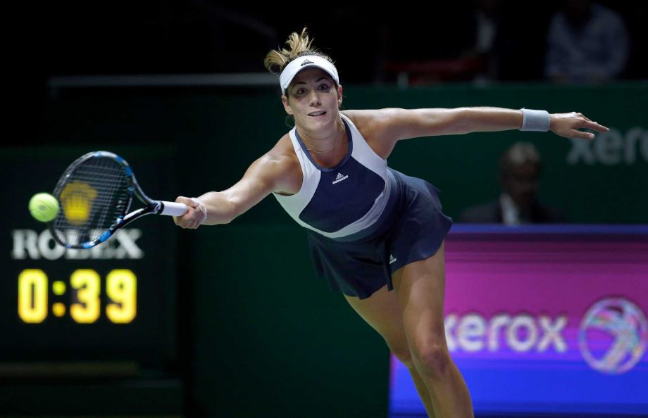 Garbine Muguruza of Spain makes a forehand return against Lucie Safarova of the Czech Republic during their singles match at the WTA tennis finals in Singapore on Monday Oct. 26 2015