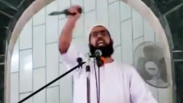 Muhammad Sallah brandishes a knife during a Friday sermon at al Abrar mosque in the Gaza Strip town of Rafah on October 9