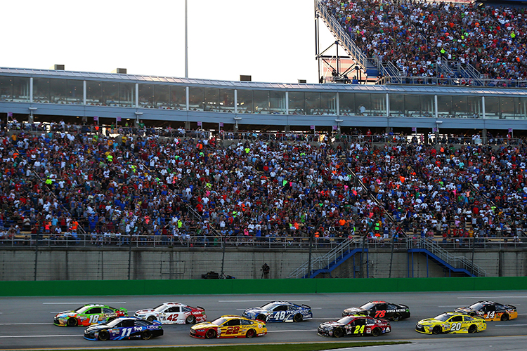 SPARTA KY- JULY 11 Kyle Busch driver of the #18 M&M's Crispy Toyota and Denny Hamlin driver of the #11 Fed Ex Office Toyota lead the field to a restart during the NASCAR Sprint Cup Series Quaker State 400 presented by Advance Auto Parts at Ken