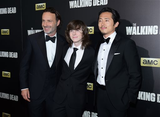 Andrew Lincoln from left Chandler Riggs and Steven Yeun attend AMC's'The Walking Dead season six premiere fan event at Madison Square Garden on Friday Oct. 9 2015 in New York