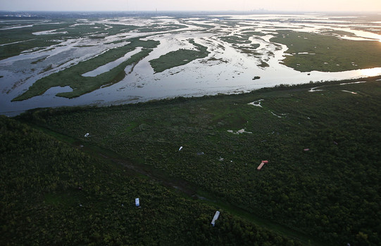 Wrecked shipping containers and other debris remain from Hurricane Katrina flooding near a wetlands area