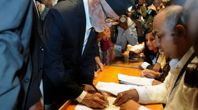 18 2015 shows Nepalese Prime Minister Sushil Koirala signing a final copy of the newly passed constitution at the parliament in Kathmandu. AFP