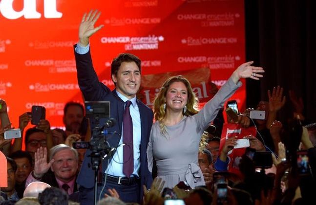 Liberal leader and incoming prime minister Justin Trudeau stands on stage with his wife Sophie Gregoire following his speechat Liberal party headquarters in Montreal early Tuesday Oct. 20 2015. THE CANADIAN PRESS  Paul Chiasson