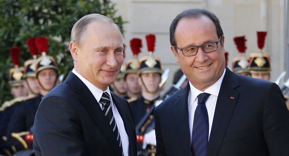 French President Francois Hollande welcomes Russia's President Vladimir Putin as he arrives attend a summit to discuss the conflict in Ukraine at the Elysee Palace in Paris France