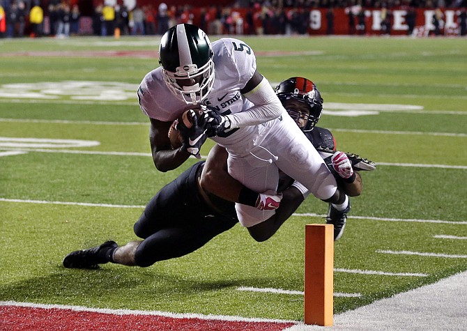 Michigan State wide receiver De Anthony Arnett dives for a touchdown as Rutgers defensive back Andre Hunt cannot make a tackle during the second half Saturday in Piscataway N.J