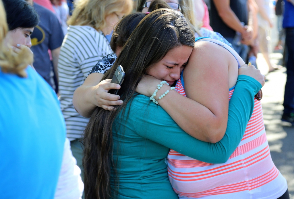 A woman is comforted as friends and family wait for students at the local fairgrounds after a shooting at Umpqua Community College in Roseburg Ore. on Thursday Oct. 1 2015