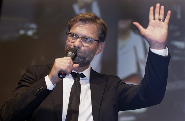 Dortmund's head coach Juergen Klopp waves during a reception in Berlin Germany after the German soccer cup final match between Borussia Dortmund and VfL Wolfsburg. Juergen Klopp is headed to Liverpool to