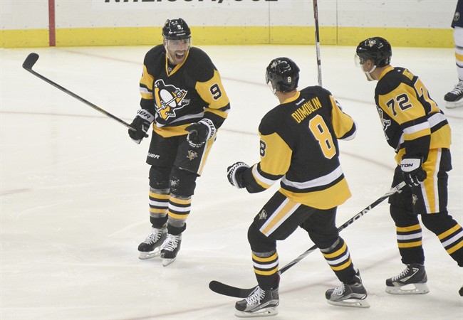 Pittsburgh Penguins right wing Pascal Dupuis celebrates with Brian Dumoulin and Patric Hornqvist after scoring a goal against the Buffalo Sabres during the first period of an NHL hockey game on Thursday Oct. 29 2015 in Pittsburgh. (AP Phot