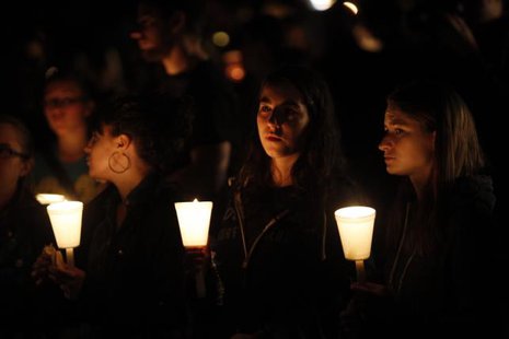 People take part in candle light vigil following a mass shooting at Umpqua Community College in Roseburg Oreg