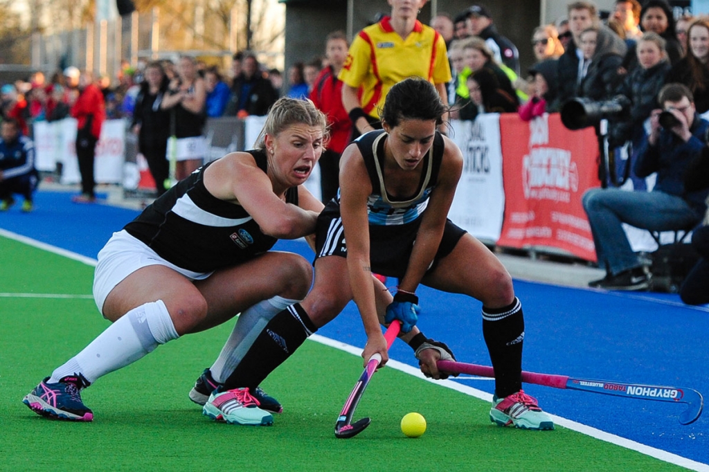 Pilar Romang of Argentina is tackled by Olivia Merry of the Black Sticks