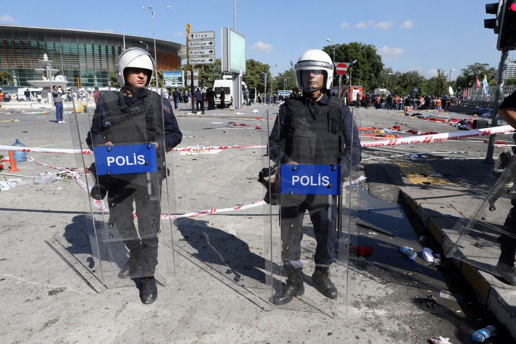 Police guard the site of the bombing outside the train station