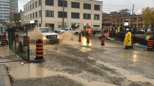 Pools of water from an autumn rainstorm flood an LRT construction site in Kitchener