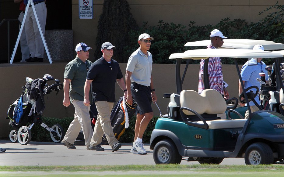 President Obama with a close security detail exits the putting green and gets ready to play Torrey Pines