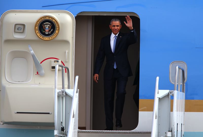 S BY ANDY NELSON AND BRIAN DAVIES- President Barack Obama waves as he deplanes from Air Force One in Oregon Friday afternoon