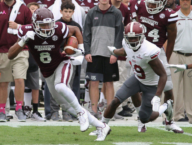 Mississippi State wide receiver Fred Ross runs from Troy cornerback Jalen Harris and for the end zone during the first half of an NCAA college football game in Starkville Miss. Saturday Oct. 10 2015