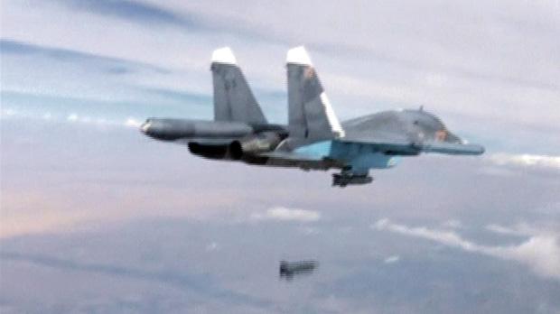 A frame grab taken from footage released by Russia’s Defence Ministry shows a Russian Su-34 fighter-bomber dropping a bomb in the air over Syria