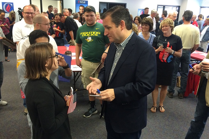 Presidential contender and U.S. Sen. Ted Cruz speaks with a supporter at the opening of his first Iowa office in Urbandale Iowa on Sept. 26 2015