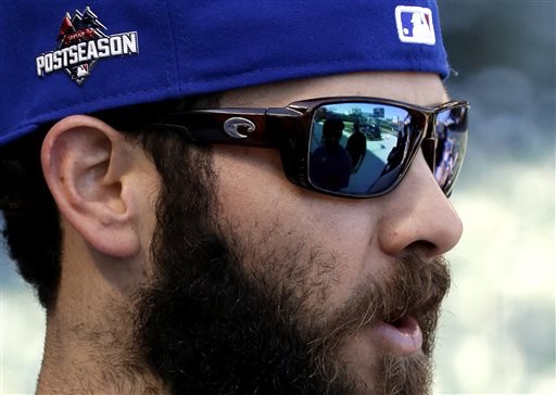 Chicago Cubs pitcher Jake Arrieta talks with teammates before an NLDS baseball practice on Sunday Oct. 11 2015 in Chicago. The Cubs are to face the St. Louis Cardinals in Game 3 of the National League Division Series on Monday