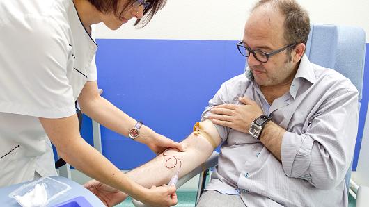 Clinical research in the GHICL. General neurology department at St Vincent de Paul hospital in Lille France. A patient suffering from multiple sclerosis in its primary progressive form. The nurse carries out a blood test