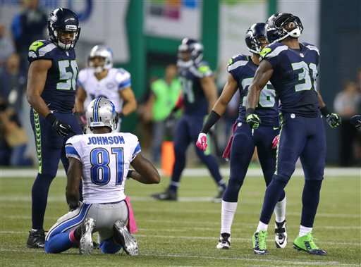 Seattle Seahawks strong safety Kam Chancellor right celebrates his tackle of Detroit Lions wide receiver Calvin Johnson in the second half of an NFL football game Monday Oct. 5 2015 in Seattle. The Seahawks beat the Lions 13-10. (AP