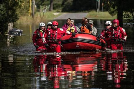 Emergency workers helped retrieve medicine and other belongings of a family near Georgetown S.C. on Sunday